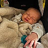 Jimmy joined the competition — help win amazing prizes! newborn, baby, sleeping, infant, child, face, hand, pacifier, blanket, car_seat, bundled, cozy, portrait, indoors, close_up, peaceful, warm_lighting, clothing, text, parenting