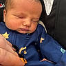 Jimmy is registered to the contest to win money with this photo: newborn, baby, sleeping, infant, child, portrait, close_up, face, eyes_closed, blue_outfit, onesie, car_seat, cozy, peaceful, hand, caregiver, indoors, sitting, textile, photography
