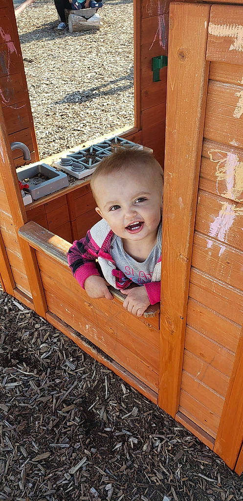 Mae is registered to the contest to win money with this photo: child, person, toddler, wood