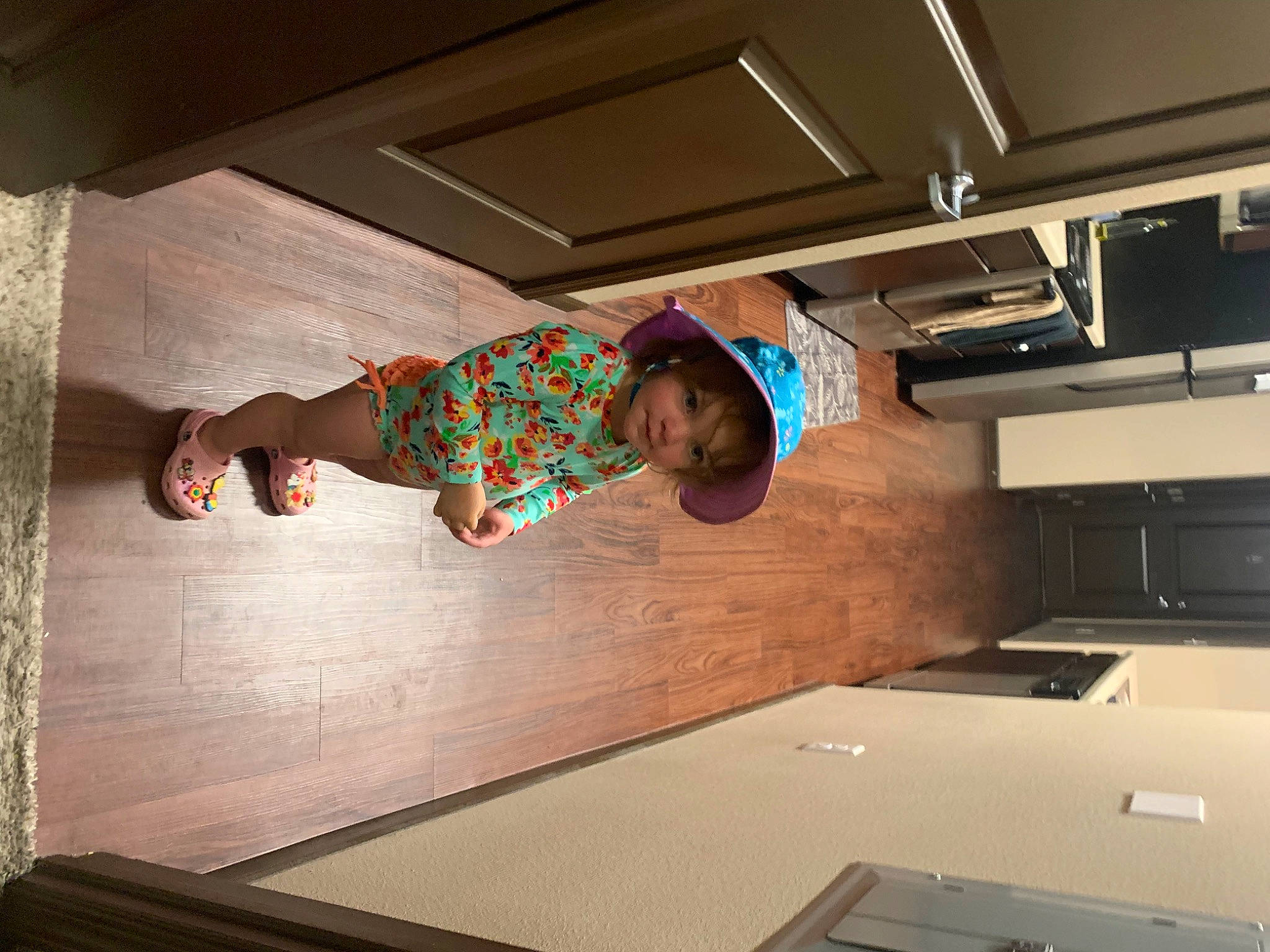 Lila is registered to the contest to win money with this photo: ceiling, child, comfort, elbow, flash_photography, floor, flooring, fun, happy, hardwood, human_leg, leisure, person, recreation, room, standing, t_shirt, toddler, wood, wood_stain