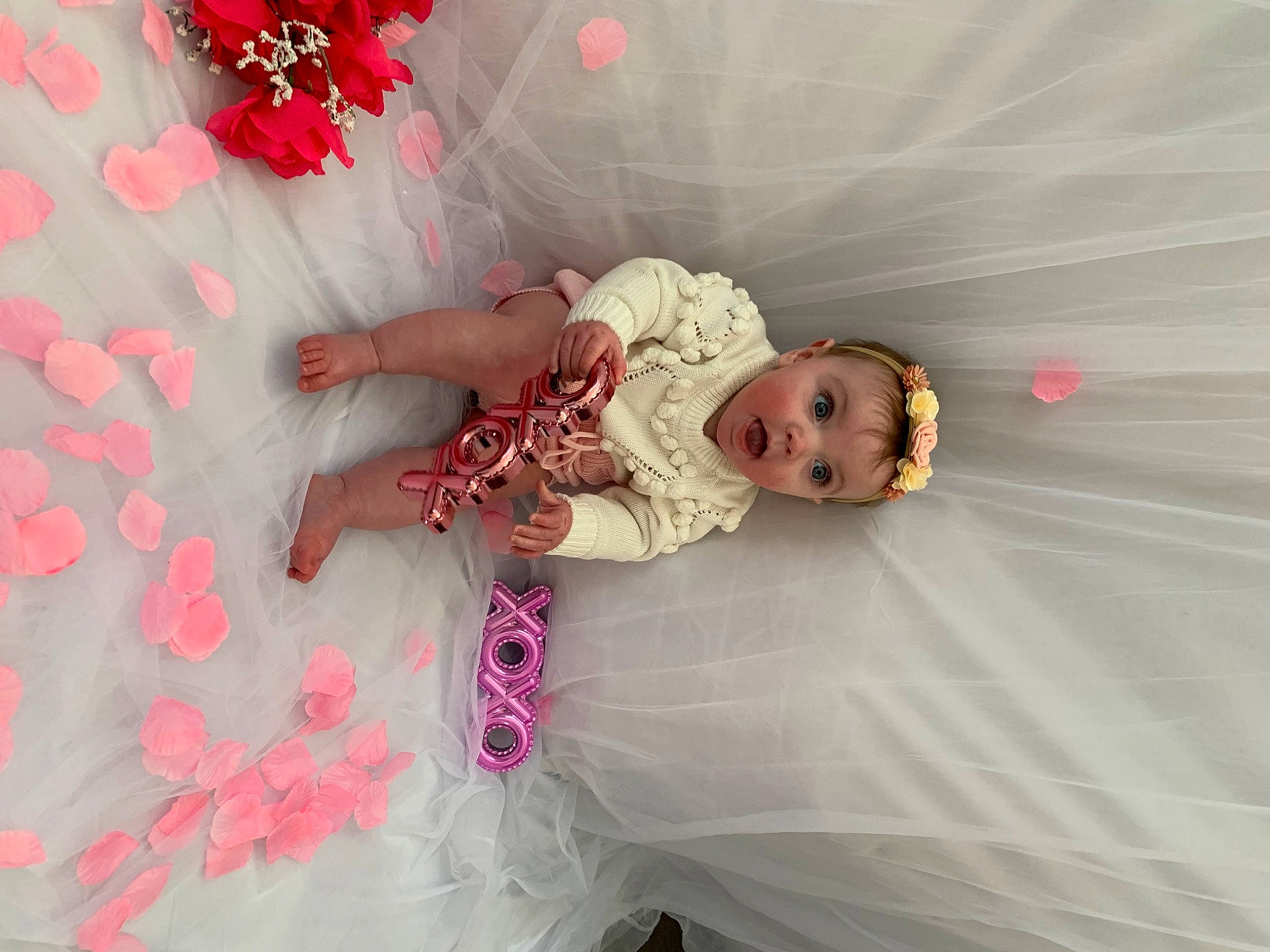 Lila is registered to the contest to win money with this photo: baby, baby_toddler_clothing, child, comfort, embellishment, event, flash_photography, flooring, fun, happy, linens, magenta, pattern, peach, person, petal, pink, room, surprise, textile