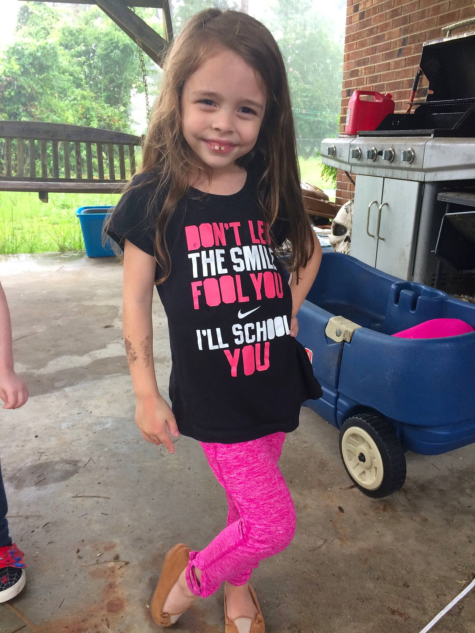 Maia is registered to the contest to win money with this photo: automotive_tire, cool, footwear, fun, hairstyle, happy, joy, leg, person, pink, shoe, shoulder, sleeve, smile, sneakers, standing, street_fashion, t_shirt, thigh, tree