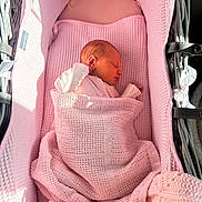 Aubrey joined the competition — help win amazing prizes! baby, newborn, sleeping, blanket, pink, bassinet, infant, swaddled, cozy, soft_light, indoors, peaceful, resting, cute, child, person, woven_texture, fabric, small, portrait