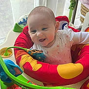 Rose is registered to the contest to win money with this photo: baby, child, smiling, activity_center, toys, indoor, playtime, colorful, infant, happy, cute, person, young_child, seat, window, natural_light, clothing, face, baby_toys, joyful