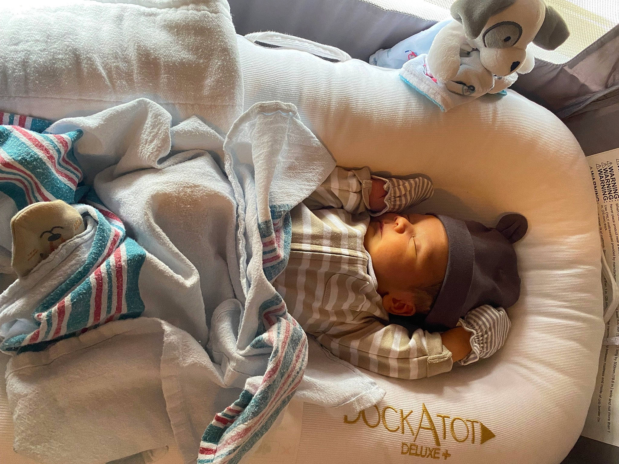 Alizae is registered to the contest to win money with this photo: abdomen, baby, barechested, barefoot, bedding, chest, child, comfort, foot, happy, human_leg, leisure, linens, muscle, person, sitting, textile, thigh, toddler, toy