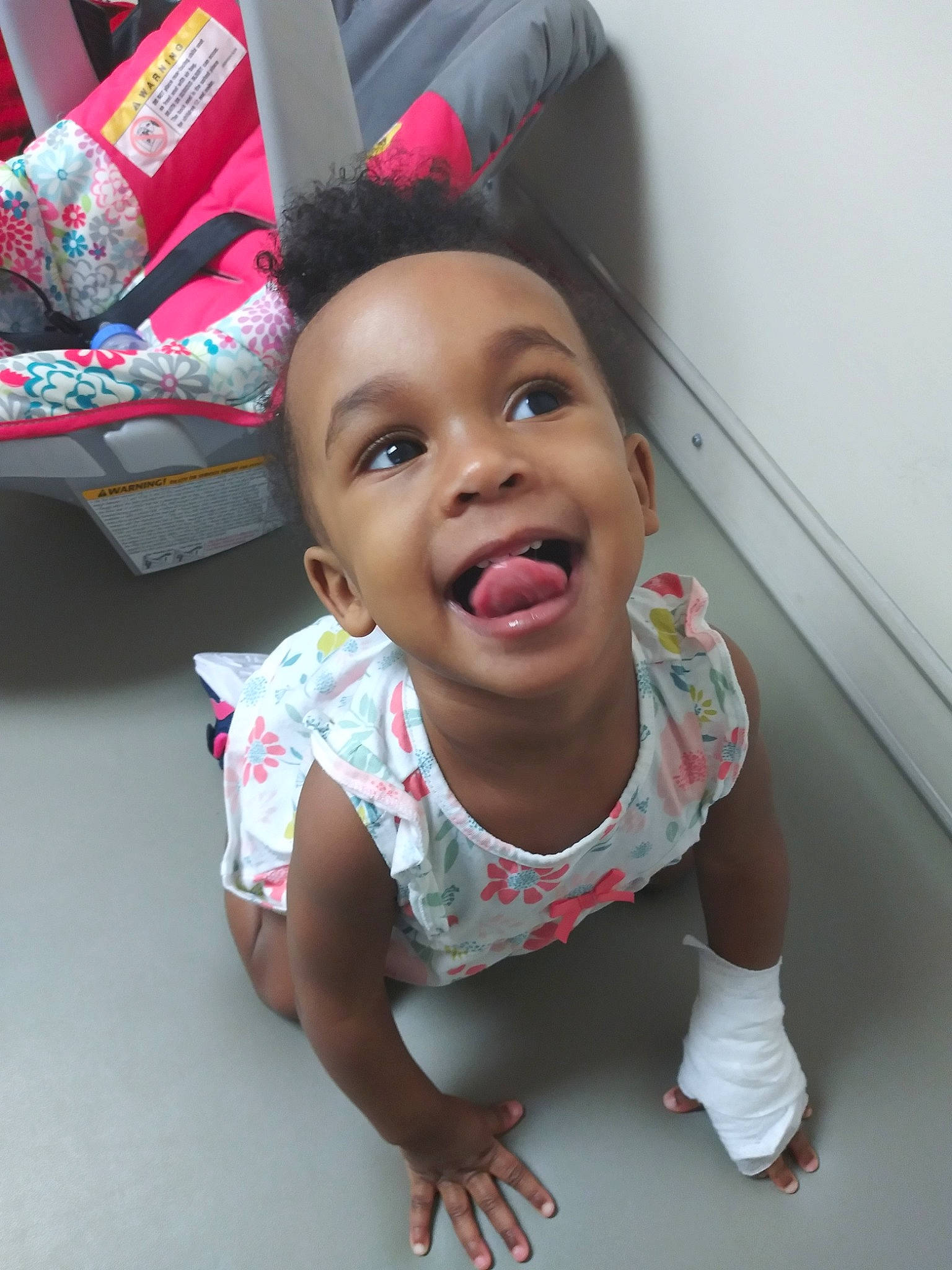 Aryah is registered to the contest to win money with this photo: baby, baby_toddler_clothing, cheek, child, eye, foot, hair_accessory, mouth, nose, person, pink, skin, sock, toddler, tongue