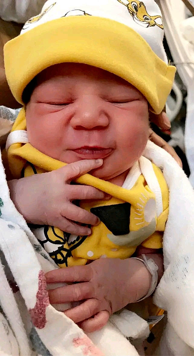 Casey is registered to the contest to win money with this photo: baby, baby_carriage, baby_products, baby_toddler_clothing, cap, cheek, child, finger, fun, gesture, green, hand, happy, hat, headwear, mouth, person, photograph, skin, smile