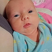 Maelee joined the competition — help win amazing prizes! baby, infant, face, onesie, blue_clothing, closeup, portrait, child, newborn, resting, blanket, soft_texture, indoor, cute, sleepwear, person, human, head, skin, peaceful