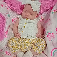 Maelee is registered to the contest to win money with this photo: baby, sleeping, headband, bow, white_clothing, floral_pants, socks, blanket, pink_blanket, soft_texture, infant, child, cute, resting, indoors, cozy, newborn, patterned_clothing, peaceful, portrait