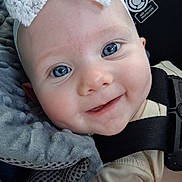 Maelee is registered to the contest to win money with this photo: baby, blue_eyes, smile, headband, lace, infant, close_up, face, car_seat, blanket, clothing, cute, child, happy, person, portrait, seatbelt, soft_texture, young, baby_girl