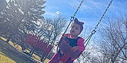 Cattleya Gómez is registered to the contest to win money with this photo: blue_sky, child, clothing, daylight, footwear, fun, grass, headband, leisure, nature, outdoor, park, person, playground, recreation, sunflare, sunlight, swing, toddler, trees