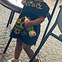Cattleya Gómez joined the competition — help win amazing prizes! bottle, carpet, casual, chair, child, clothing, dress, flower, footwear, girl, headband, headwear, holding, indoor, person, standing, sunflower, toddler, white_crocs, young_child