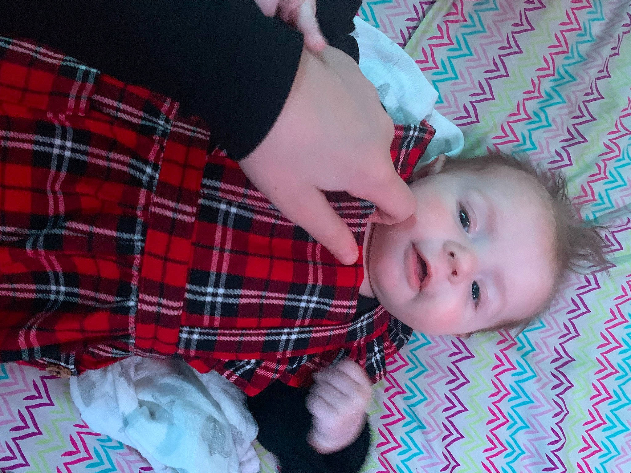 Ansley is registered to the contest to win money with this photo: baby, baby_toddler_clothing, cheek, child, comfort, finger, gesture, grass, happy, pattern, person, plaid, sitting, skin, sleeve, smile, tartan, textile, toddler, tree
