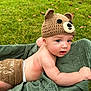 Everett joined the competition — help win amazing prizes! baby, infant, knitted_hat, bear_hat, diaper_cover, green_blanket, grass, outdoor, cute, blue_eyes, skin, child, lying_down, nature, soft_texture, headwear, expression, candid, young, adorable