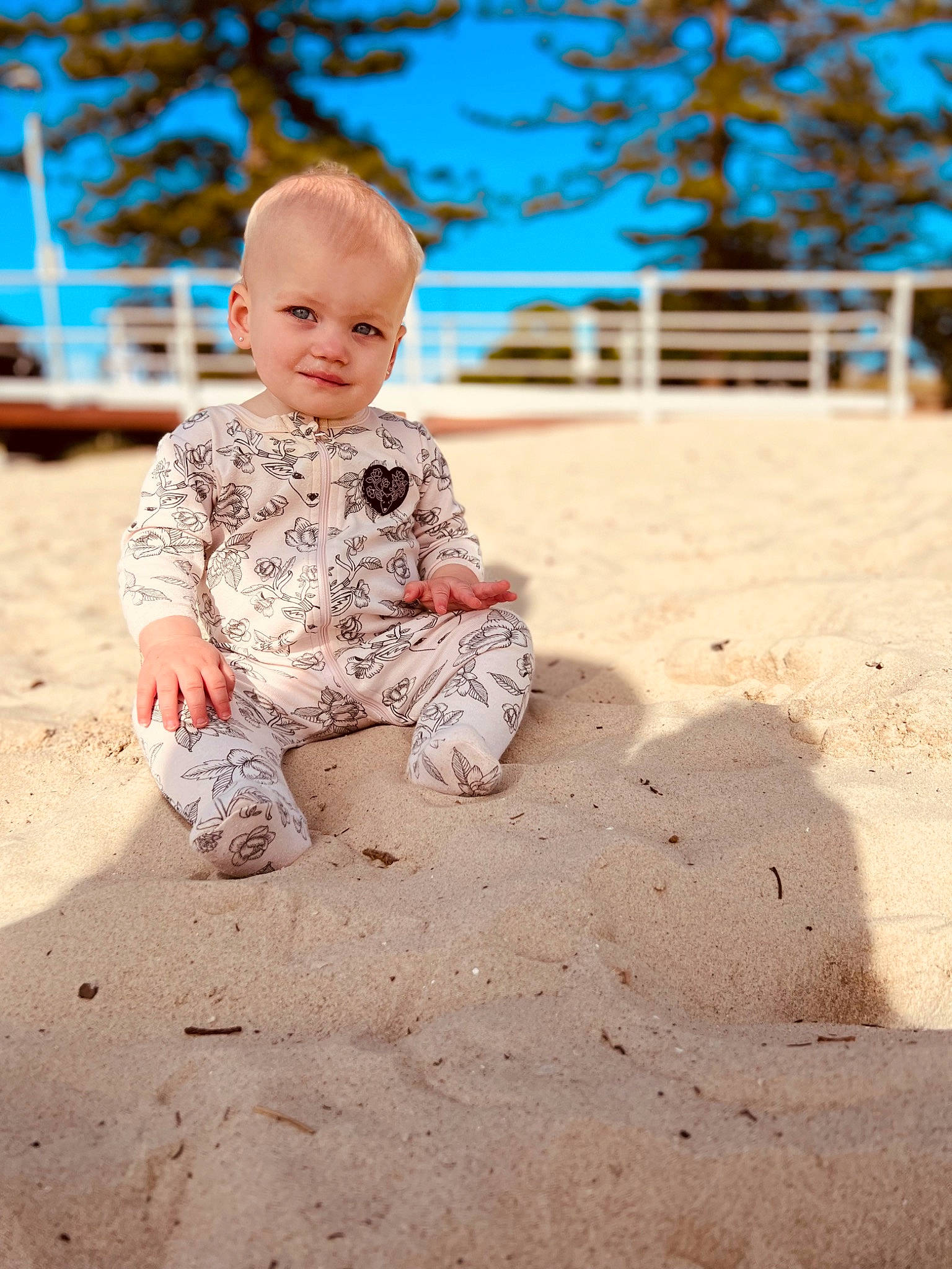 Marlee is registered to the contest to win money with this photo: baby, baby_toddler_clothing, body_of_water, child, flash_photography, flooring, fun, grass, happy, joy, leisure, people_in_nature, person, play, sand, sitting, sky, smile, soil, toddler