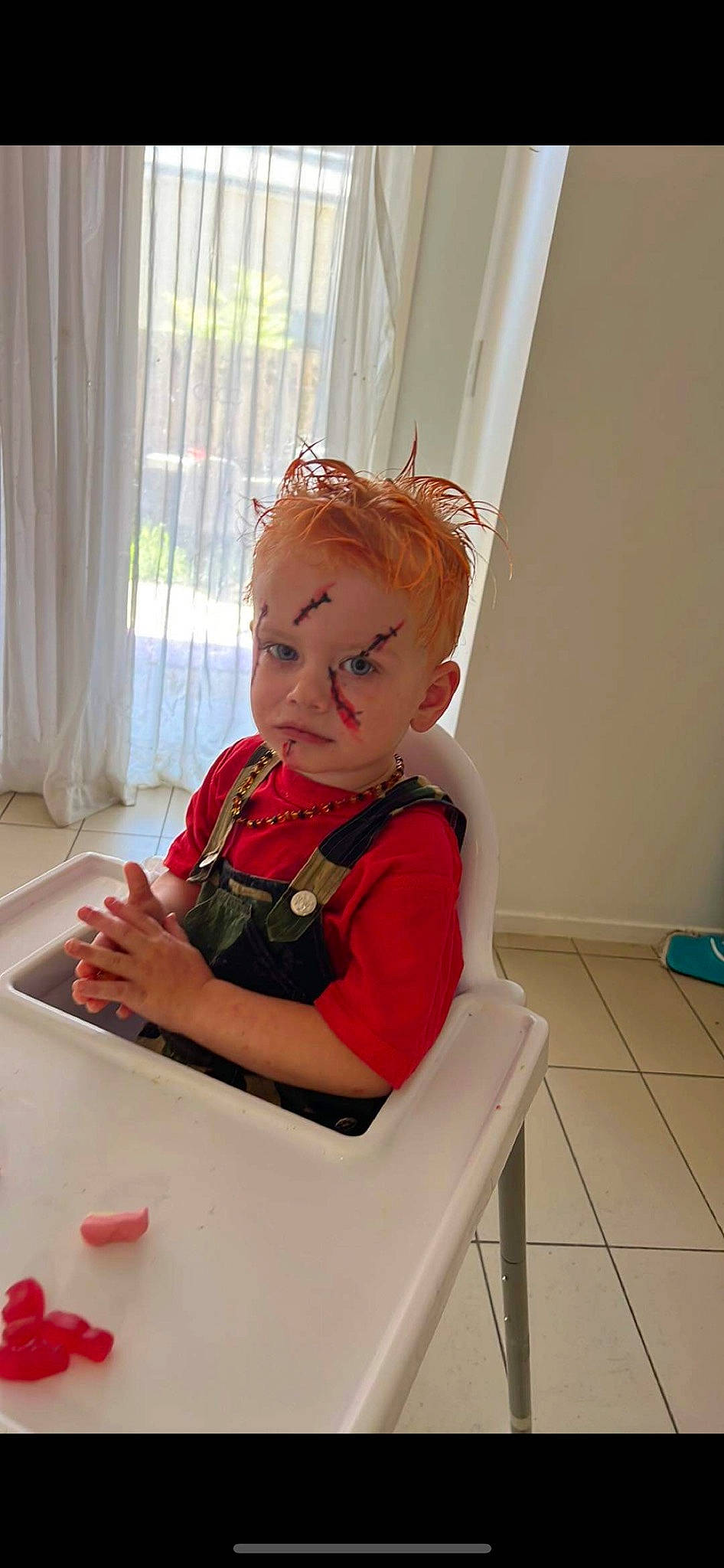 Myles is registered to the contest to win money with this photo: baby, baby_toddler_clothing, carmine, chair, child, comfort, curtain, flooring, hair, person, plate, play, red, room, sitting, sleeve, table, toddler, window, window_treatment