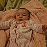 baby, infant, child, portrait, lying_down, blanket, pink_blanket, bed, indoors, home, cozy, onesie, polka_dots, patterned_clothing, facial_expression, open_eyes, looking_at_camera, warm_lighting, close_up, cute