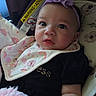 Harmony joined the competition — help win amazing prizes! baby, infant, child, portrait, car_seat, headband, flower, purple, bib, rainbow, blanket, black_clothing, sitting, face, eyes, tongue, indoors, vehicle, close_up, photography