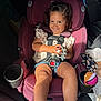 Sloane joined the competition — help win amazing prizes! toddler, child, car_seat, toy, smile, sunlight, car_interior, seatbelt, clothing, shorts, shoes, cup_holder, hair, face, person, sitting, happy, safety, play, vehicle