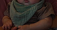 Simeon is registered to the contest to win money with this photo: adult, baby, bib, casual, child, clothing, cozy, curly_hair, drool, face, food_menu, glasses, hands, holding, indoor, person, portrait, seated, table, warm_lighting