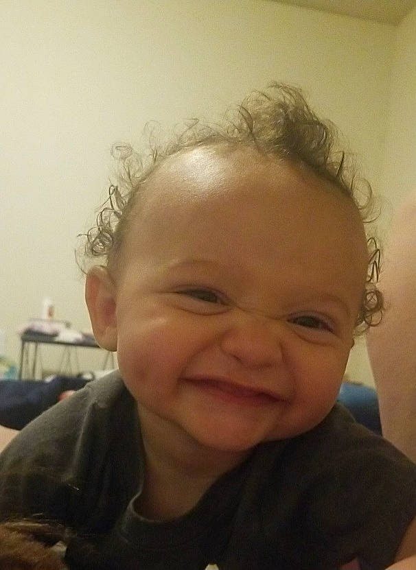 Jordan is registered to the contest to win money with this photo: baby, cheek, chin, ear, eye, eyebrow, eyelash, finger, forehead, gesture, happy, iris, jaw, joy, lip, mouth, neck, nose, person, skin