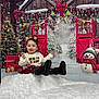Vada is registered to the contest to win money with this photo: toddler, child, smiling, jumping, christmas, holiday, festive_clothing, snowman, christmas_tree, presents, red_bow, garland, winter_scene, north_pole_sign, decorations, blanket, indoor, happy, cute, celebration