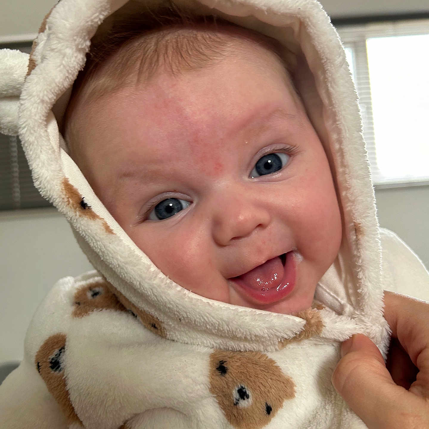 Flossie is registered to the contest to win money with this photo: baby, bodypart, clothing, face, finger, hand, happy, hat, head, hood, hoodie, knitwear, person, photography, portrait, smile, sweater, sweatshirt, teddybear, toy