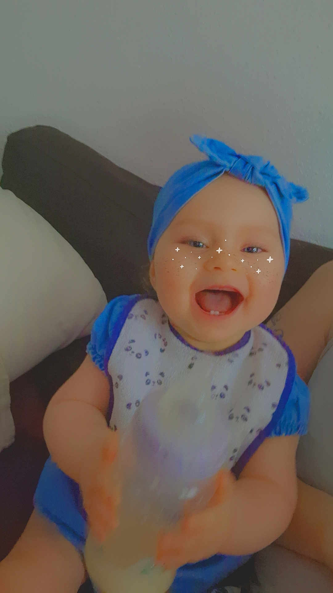 Ambre a rejoint le concours — aidez-le/la à gagner de superbes lots ! baby, bottle, blue_headband, bib, couch, happy, infant, milk, person, portrait, sitting, smile, sparkles, headwear, child, indoor, clothing, face, cute, pillow