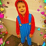Diego participe au concours pour gagner de l'argent avec cette photo : child, bathroom, onesie, red_hood, blue_overalls, smiling, face, slippers, tile_wall, bathtub, bathmat, heart, flower, butterfly, ladybug, bee, mushroom, cartoon_overlay, colorful, standing