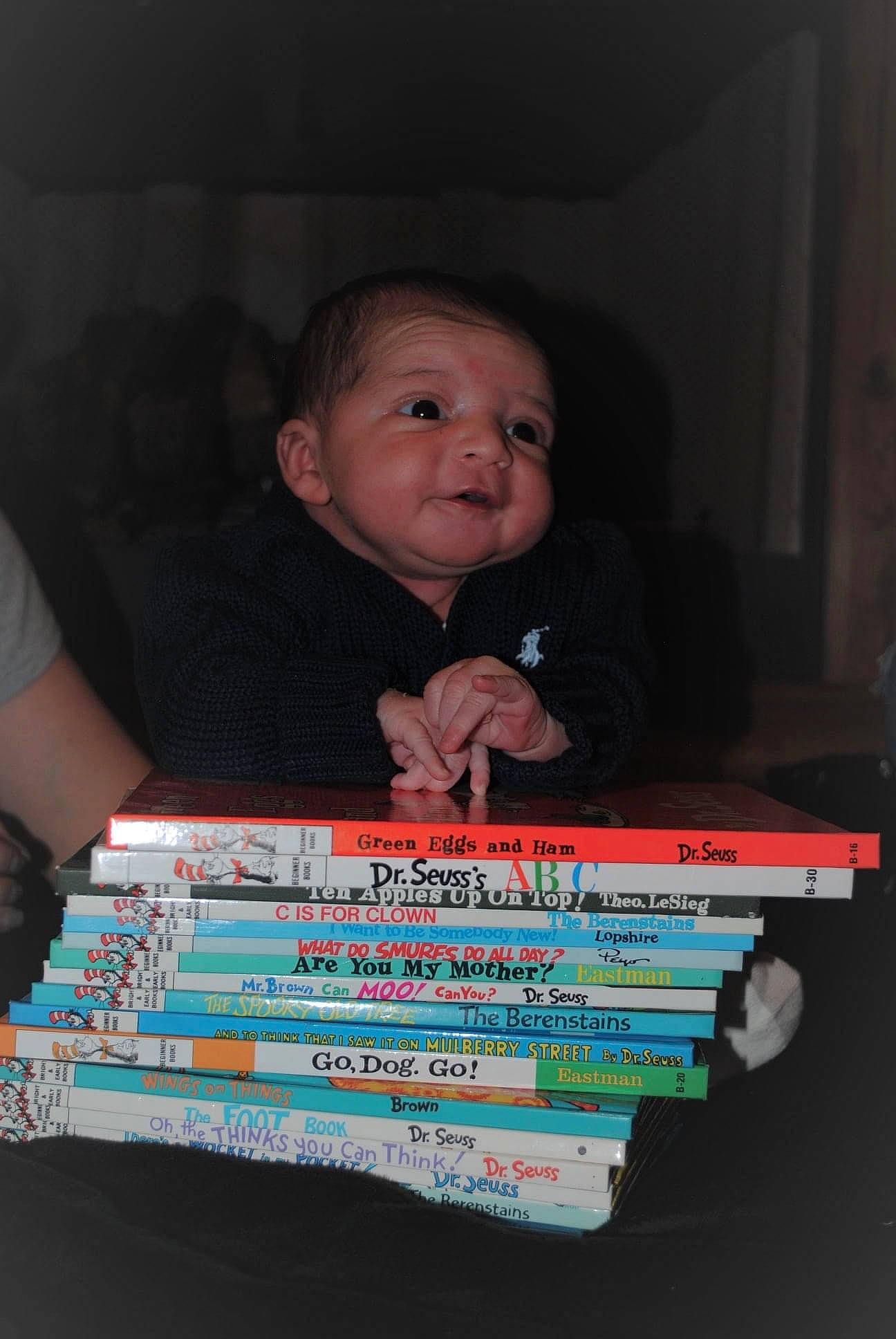 Ahmir is registered to the contest to win money with this photo: baby, cheek, child, darkness, electric_blue, fun, indoor_games_and_sports, iris, person, publication, recreation, room, sitting, table, toddler, wood