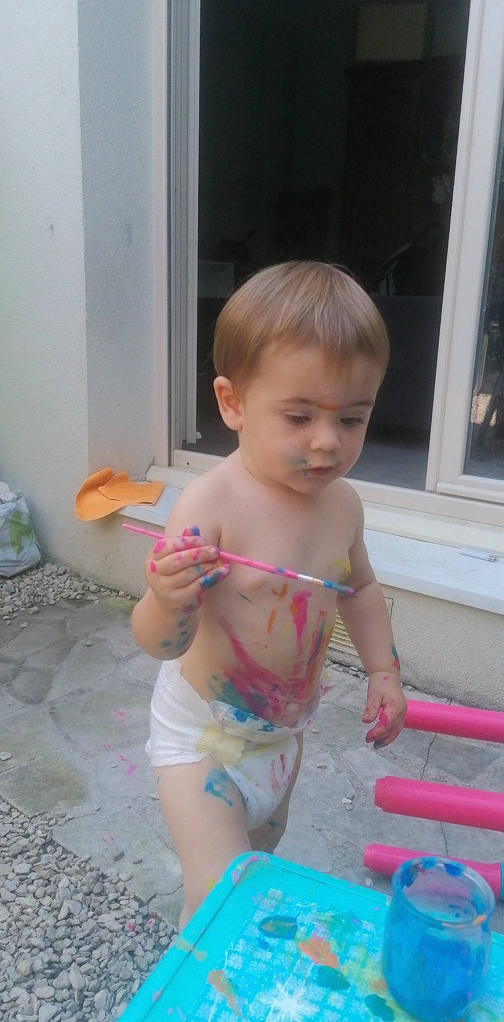 Thyago participe au concours pour gagner de l'argent avec cette photo : baby, bathing, chest, child, diaper, flooring, fun, head, human_leg, leisure, navel, person, pink, play, sitting, swimwear, thigh, toddler, trunk, underpants