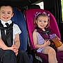 boy, car_interior, car_seat, casual, child, children, clothing, girl, greenery, happy, interior, portrait, purple_bow, road_trip, safety, seat, seat_belt, sippy_cup, smile, window