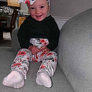 Amara joined the competition — help win amazing prizes! architecture, baby, building, clothing, couch, cushion, face, furniture, head, homedecor, hosiery, indoors, pajamas, pants, person, photography, portrait, scarf, sitting, sock