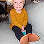 Amara is registered to the contest to win money with this photo: boy, child, clothing, couch, cushion, face, footwear, furniture, head, homedecor, hosiery, knitwear, male, pants, person, photography, portrait, shoe, sitting, sock