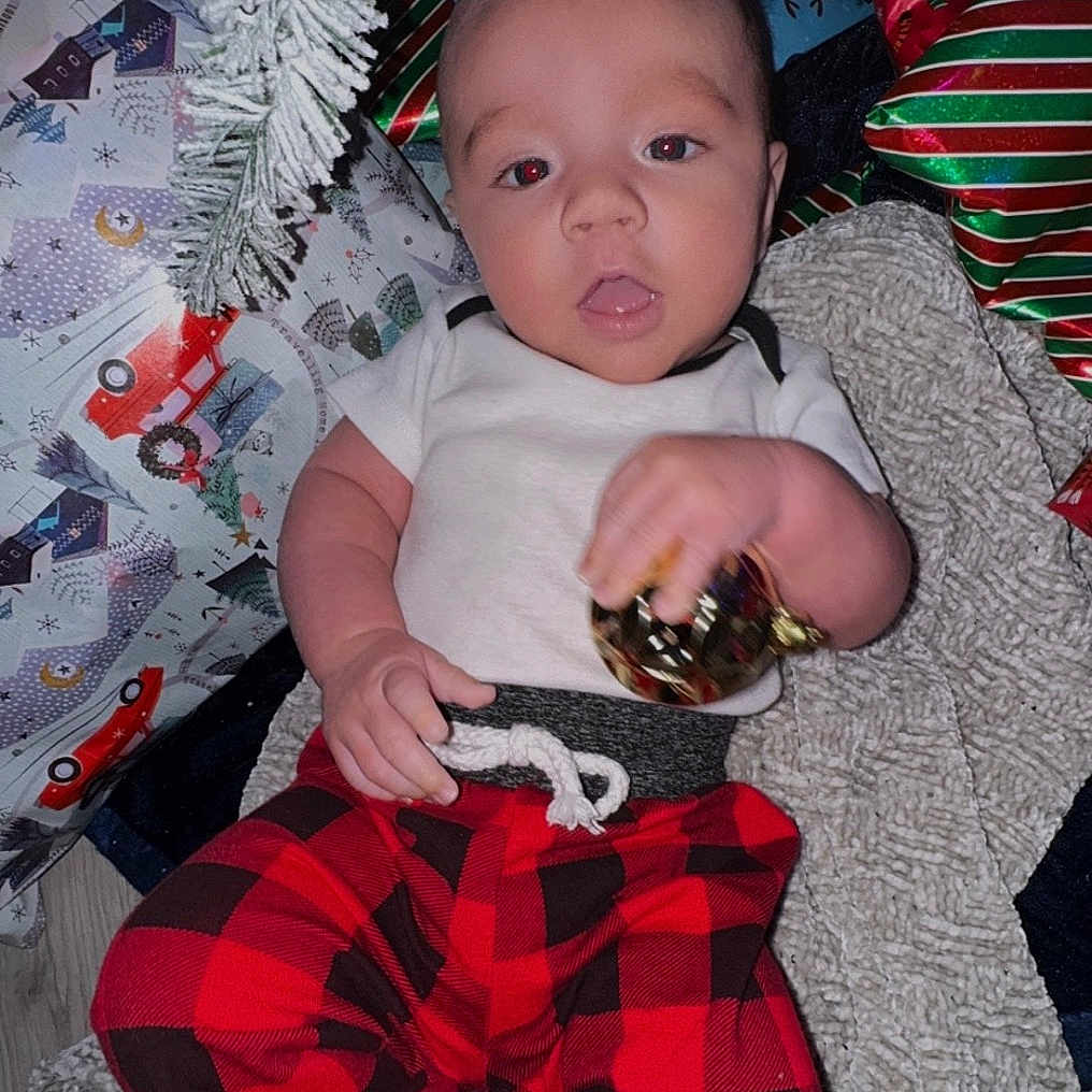 Grayson is registered to the contest to win money with this photo: baby, blanket, bodypart, clothing, couch, cushion, face, finger, fir, furniture, hand, hat, head, homedecor, pants, person, photography, plant, portrait, shorts