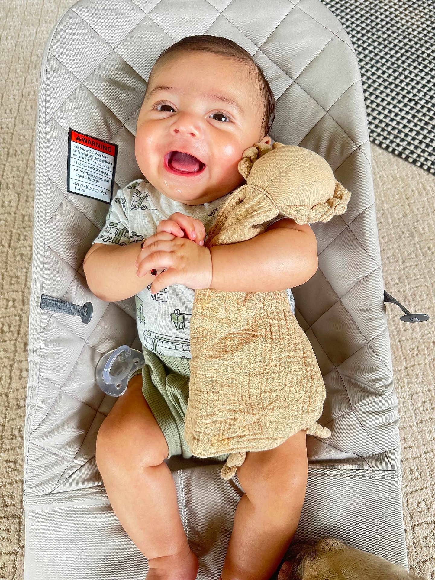 James joined the competition — help win amazing prizes! baby, smiling, infant, baby_seat, toy, pacifier, clothing, carpet, fabric, hand, face, cute, child, indoor, person, seat, happy, soft_toy, lying_down, blanket
