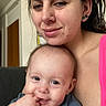 Axl joined the competition — help win amazing prizes! arm, baby, background, casual, clothing, couch, earring, expression, face, hair, hand, holding, indoor, nose_piercing, person, portrait, skin, smile, toddler, woman