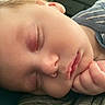 baby, child, close_up, cute, eyelashes, face, hand, indoors, infant, lips, nose, onesie, peaceful, portrait, resting, rosy_cheeks, skin, sleeping, soft_light, striped_clothing