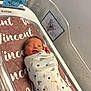 Vincent is registered to the contest to win money with this photo: newborn, baby, swaddled, hospital, bassinet, blanket, face, winking, towel, baby_boy, infant, footprint_art, hospital_card, cute, sleeping, wrapped, indoor, crib, person, child