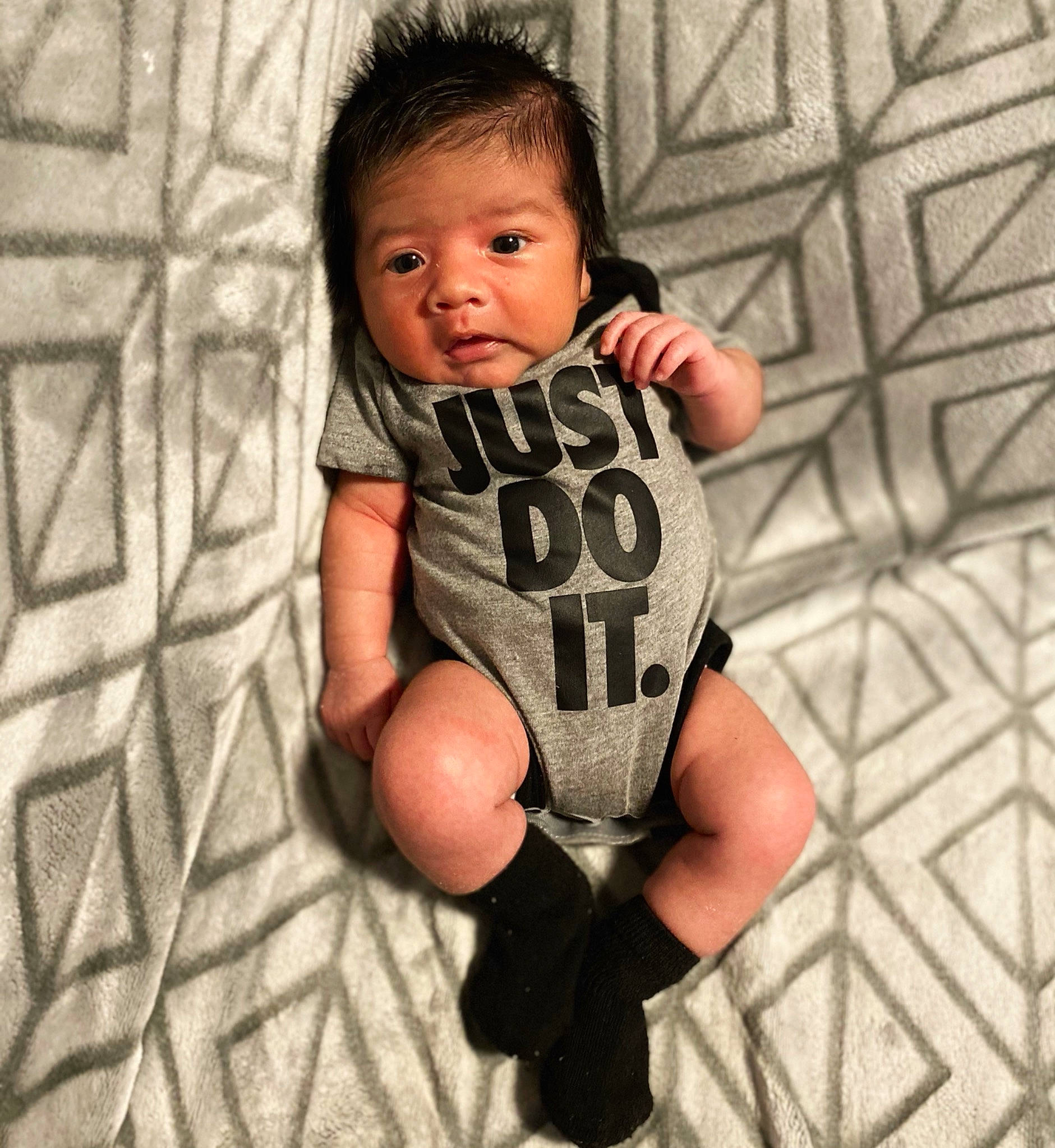Marcel is registered to the contest to win money with this photo: arm, baby, baby_toddler_clothing, comfort, face, flash_photography, flooring, hand, happy, human_body, human_leg, infant_bodysuit, leg, nail, pattern, person, sleeve, t_shirt, thigh, thumb