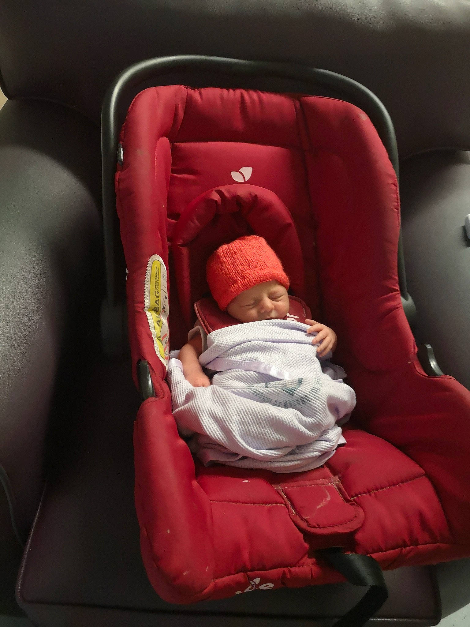 Paige joined the competition — help win amazing prizes! armrest, baby, baby_in_car_seat, baby_products, baby_sleeping, baby_toddler_clothing, beanie, car_seat, car_seat_cover, carmine, child, comfort, head_restraint, headwear, lap, nap, person, product, red, sitting