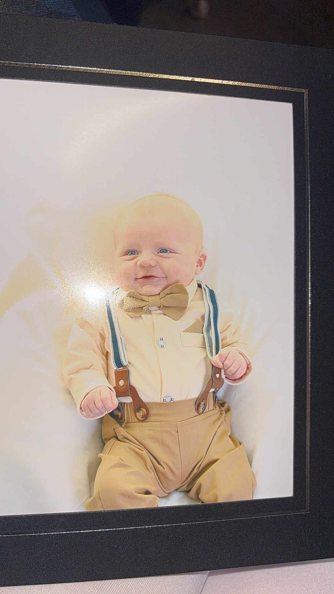 Oakley-Jay joined the competition — help win amazing prizes! baby, child, portrait, smile, bow_tie, suspenders, beige_clothing, infant, formal_wear, framed_photo, cute, happy, face, person, baby_boy, indoor, seated, clothing, hands, head