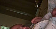 Delilah is registered to the contest to win money with this photo: baby, adult, smile, face, pajamas, bedroom, curtains, indoor, person, child, closeup, love, affection, cozy, sleepwear, interaction, parent, infant, happy, bonding