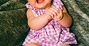 Delilah is registered to the contest to win money with this photo: baby, child, smiling, happy, pink_bow, headband, dress, purple, checkered, clapping, barefoot, sitting, blanket, cozy, cute, portrait, indoor, infant, skin, person
