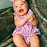 baby, child, smiling, happy, pink_bow, headband, dress, purple, checkered, clapping, barefoot, sitting, blanket, cozy, cute, portrait, indoor, infant, skin, person