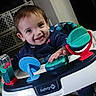 baby, child, toddler, smiling, happy, portrait, indoor, activity_walker, toy, playtime, infant, face, eyes, hair, clothing, seated, furniture, home, colorful, photography