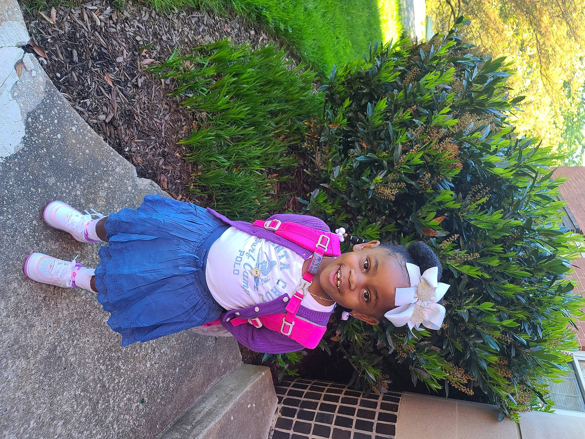 Avah is registered to the contest to win money with this photo: asphalt, baby_toddler_clothing, botany, child, electric_blue, flower, fun, garden, grass, groundcover, hat, joy, leaf, leisure, magenta, people_in_nature, person, plant, purple, shrub