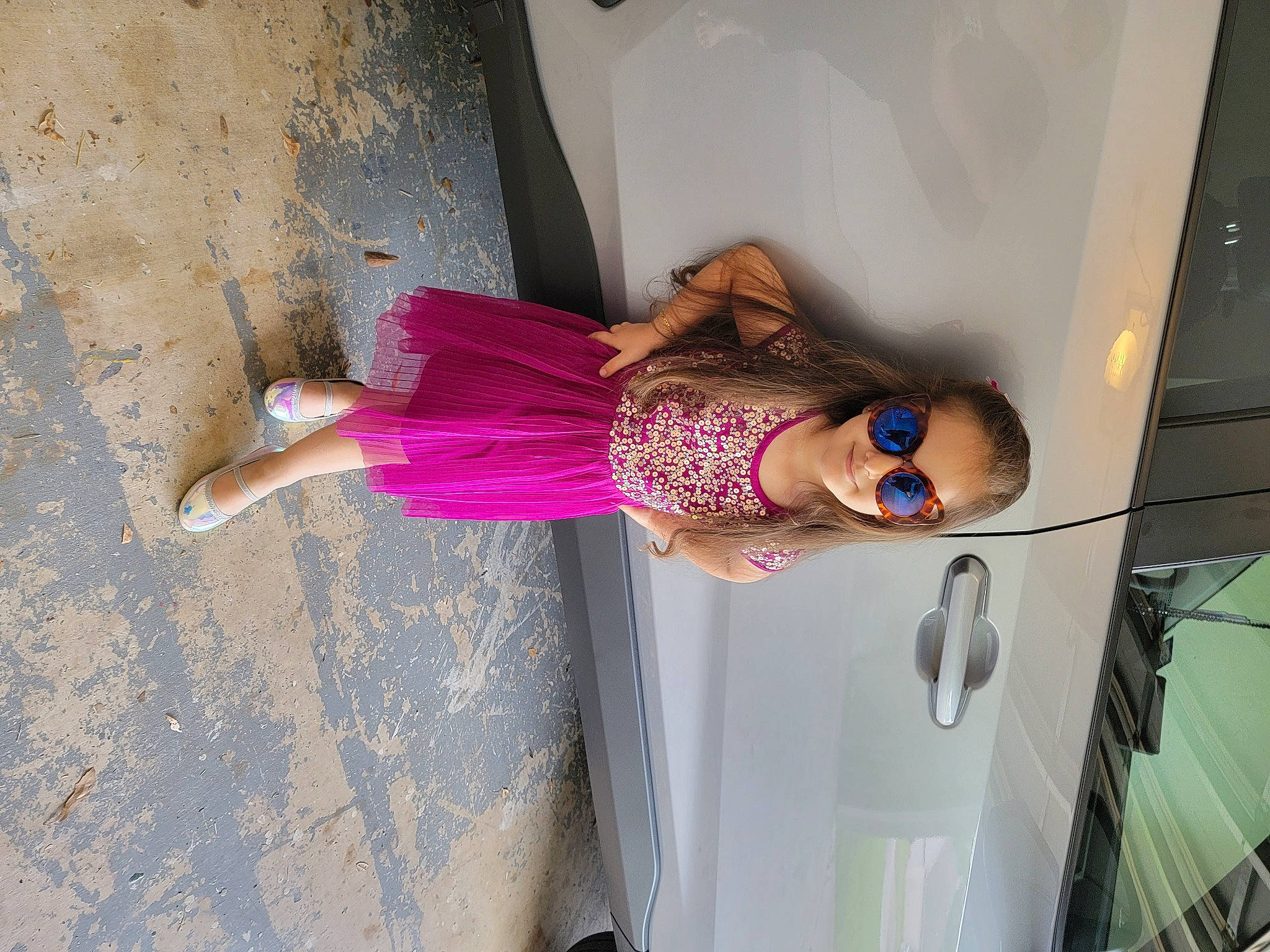 Leyla is registered to the contest to win money with this photo: car, day_dress, dress, face, fun, human_leg, leg, magenta, person, pink, purple, smile, street_fashion, thigh, tints_and_shades, tire, vehicle_door, waist, water, wheel