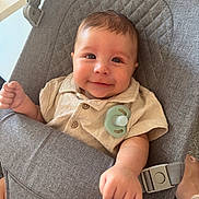Arlo is registered to the contest to win money with this photo: baby, infant, smile, face, clothing, pacifier, seat, fabric, child, cute, comfort, indoor, skin, hand, button, head, person, expression, portrait, young