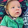 baby, child, dinosaur_hat, green_shirt, outdoor, sunlight, person, adult, hand, face, curious, holding, patterned_clothing, blue_sky, summer, headwear, cute, portrait, infant, casual